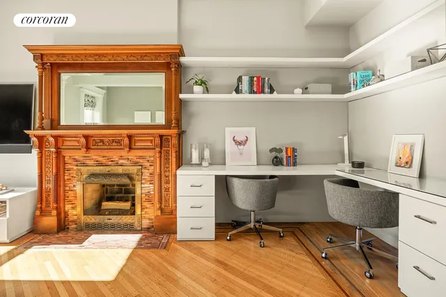 a living room with a couch a fireplace a flat screen tv and windows