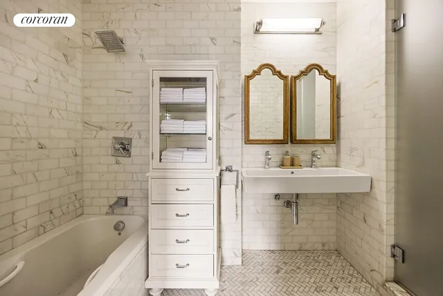 a spacious bedroom with a bed and a fireplace