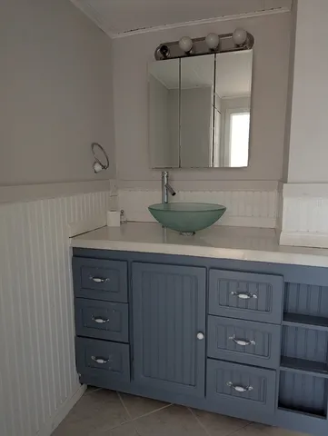 a bathroom with a granite countertop sink and mirror
