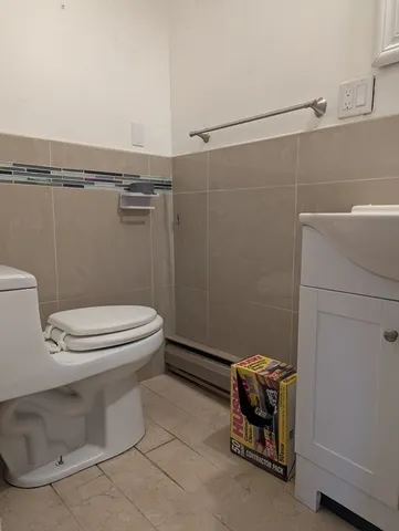 a white toilet sitting next to a bathroom sink