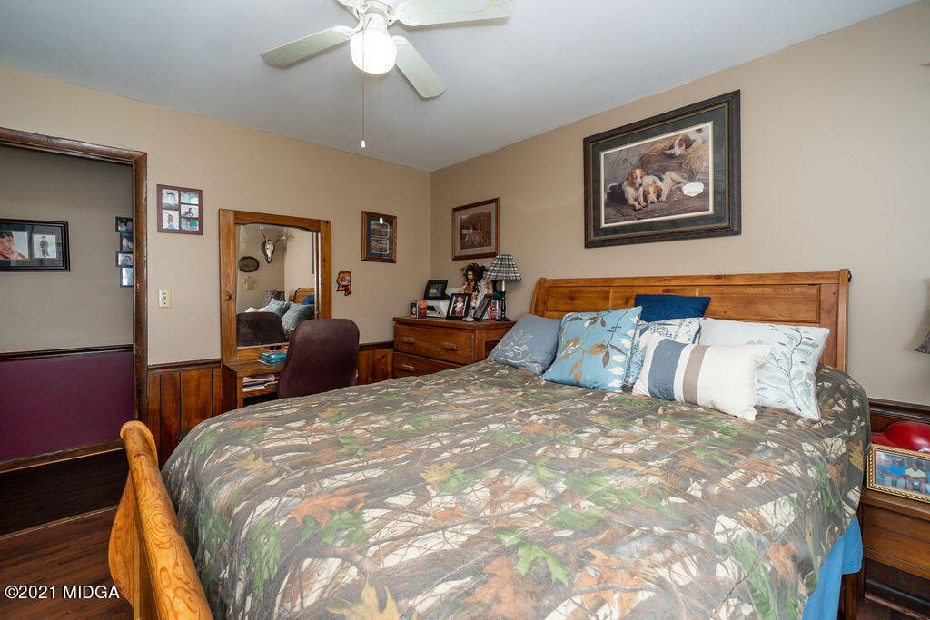 156 Walton Road Fort Valley, GA 31030 - Photo 27 of 61 a bedroom with a large bed and a chandelier