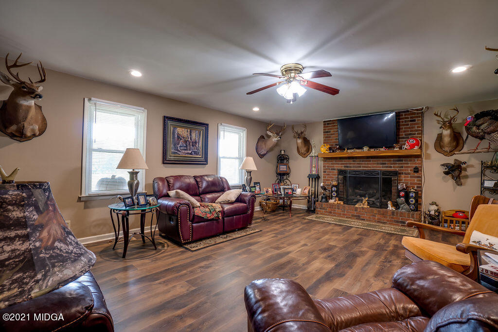 156 Walton Road Fort Valley, GA 31030 - Photo 4 of 61 a living room with furniture a fireplace and a flat screen tv