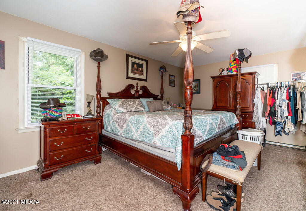 156 Walton Road Fort Valley, GA 31030 - Photo 32 of 61 a bedroom with a bed and a chandelier