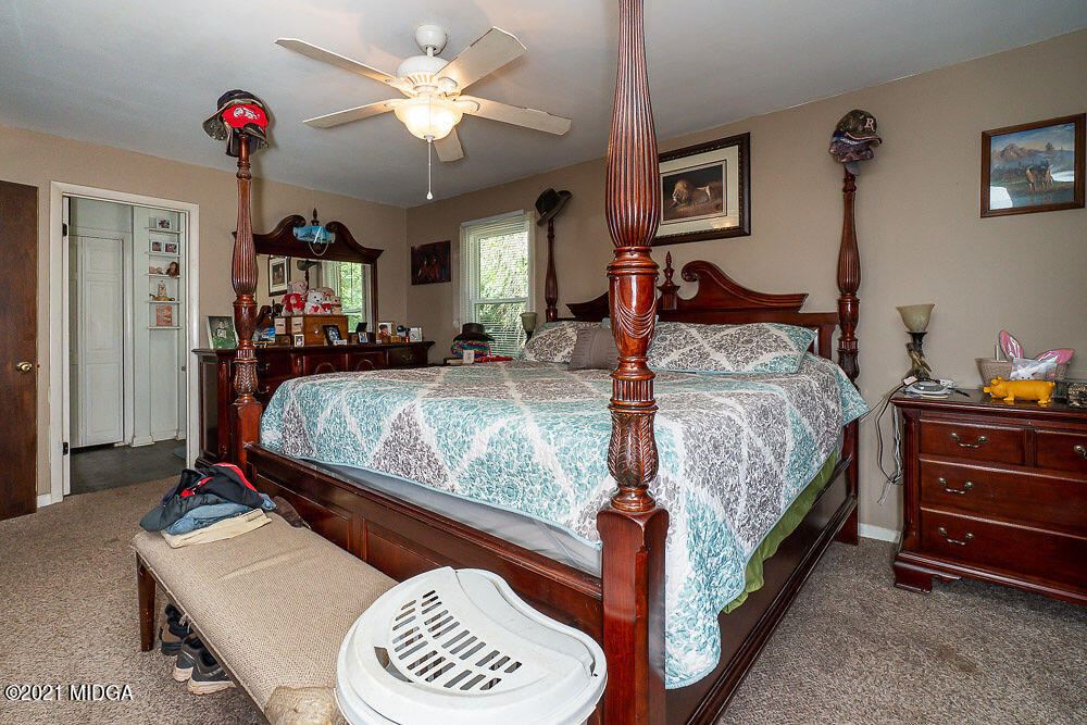 156 Walton Road Fort Valley, GA 31030 - Photo 33 of 61 a bedroom with bed and a chandelier