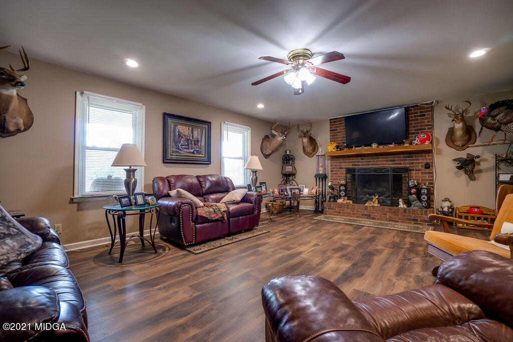156 Walton Road Fort Valley, GA 31030 - Photo 5 of 61 a living room with furniture a fireplace and a flat screen tv