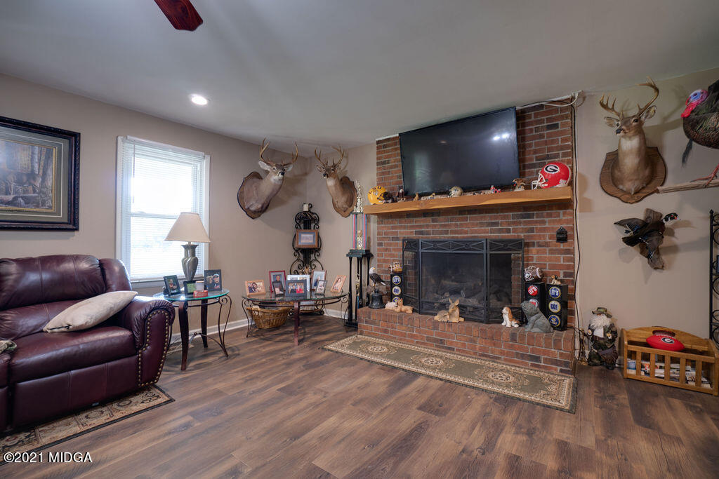 156 Walton Road Fort Valley, GA 31030 - Photo 7 of 61 a living room with furniture a flat screen tv and a fireplace