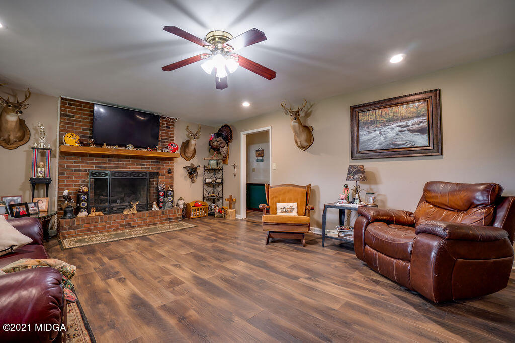 156 Walton Road Fort Valley, GA 31030 - Photo 10 of 61 a living room with furniture a flat screen tv and a fireplace