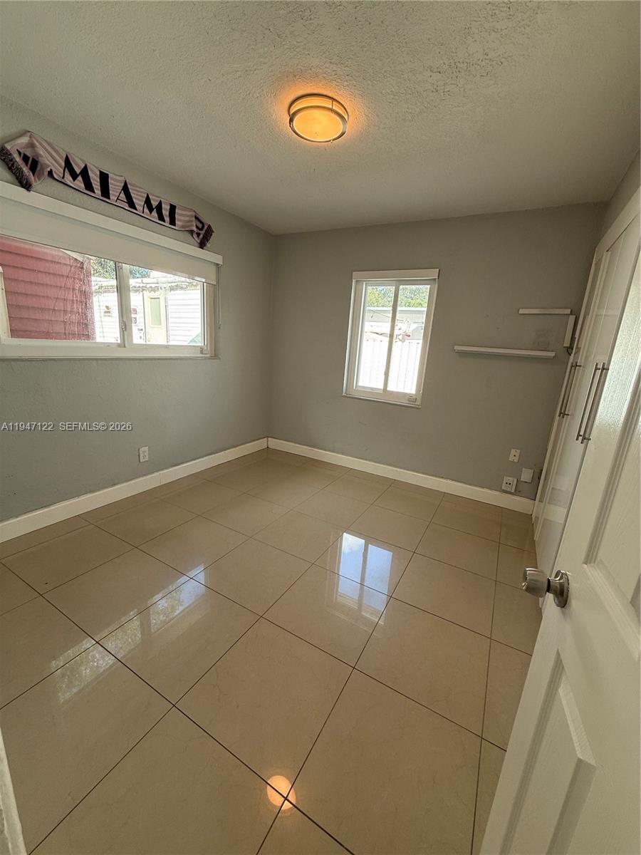 5715 Arthur Street Hollywood, FL 33021 - Photo 7 of 15 a view of an empty room with a window