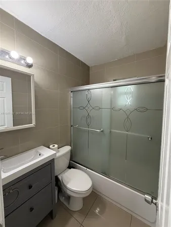 a bathroom with a toilet sink and shower