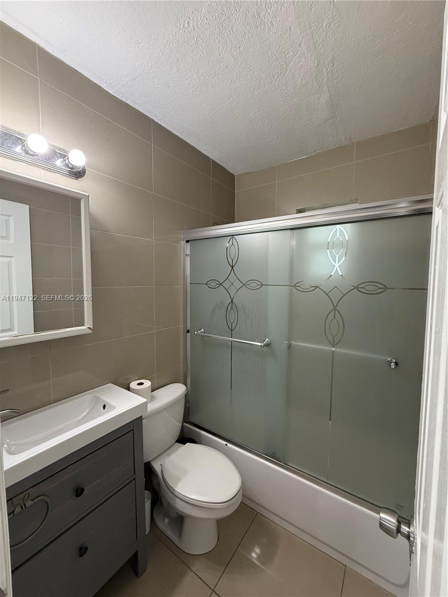 5715 Arthur Street Hollywood, FL 33021 - Photo 8 of 15 a bathroom with a toilet sink and shower