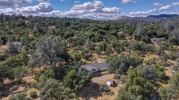an aerial view of a houses with a yard