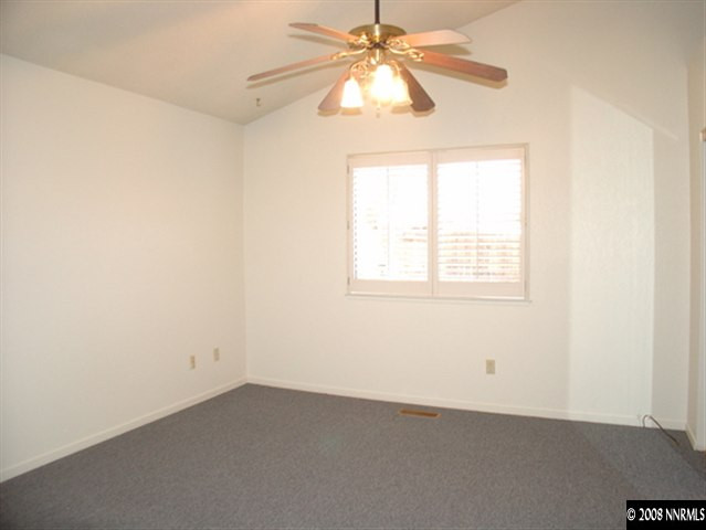 5877 Bankside Way Reno, NV 89523 - Photo 5 of 9 an empty room with a window and a fan