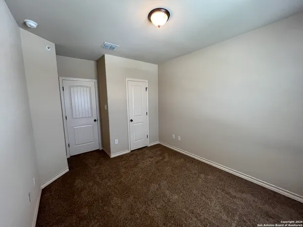 an empty room with closet area