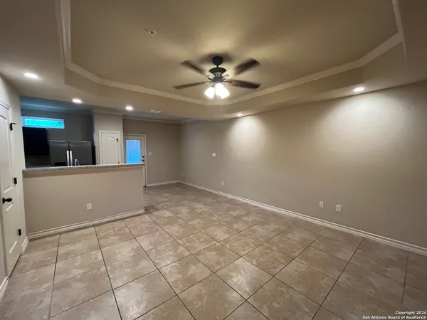 a view of a kitchen with a sink and a chandelier fan