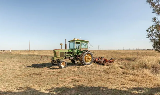 a living room with a bed and window