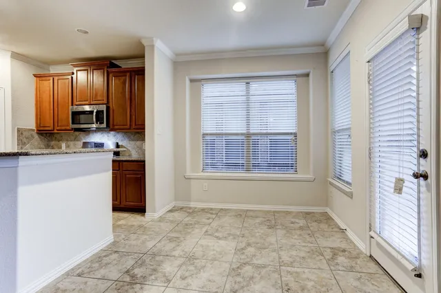 a view of a kitchen with a sink and a refrigerator