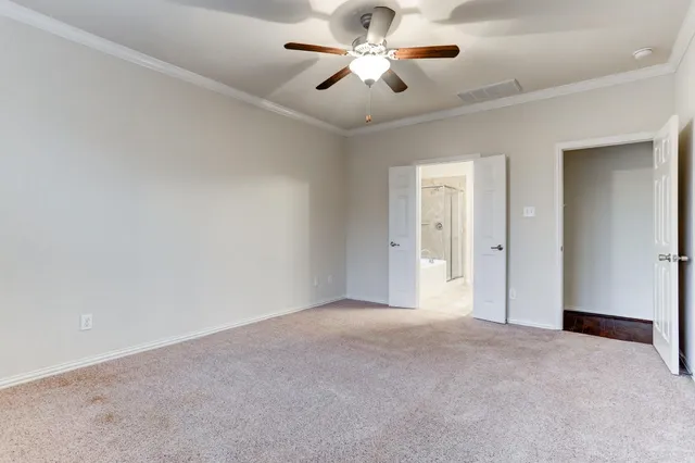 a view of a big room with chandelier fan and windows