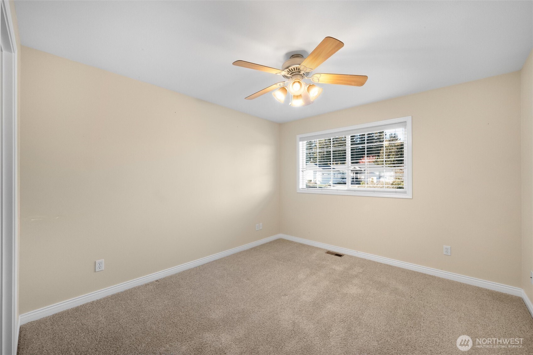 8148 Quinault Road Blaine, WA 98230 - Photo 19 of 40 an empty room with a window and ceiling fan