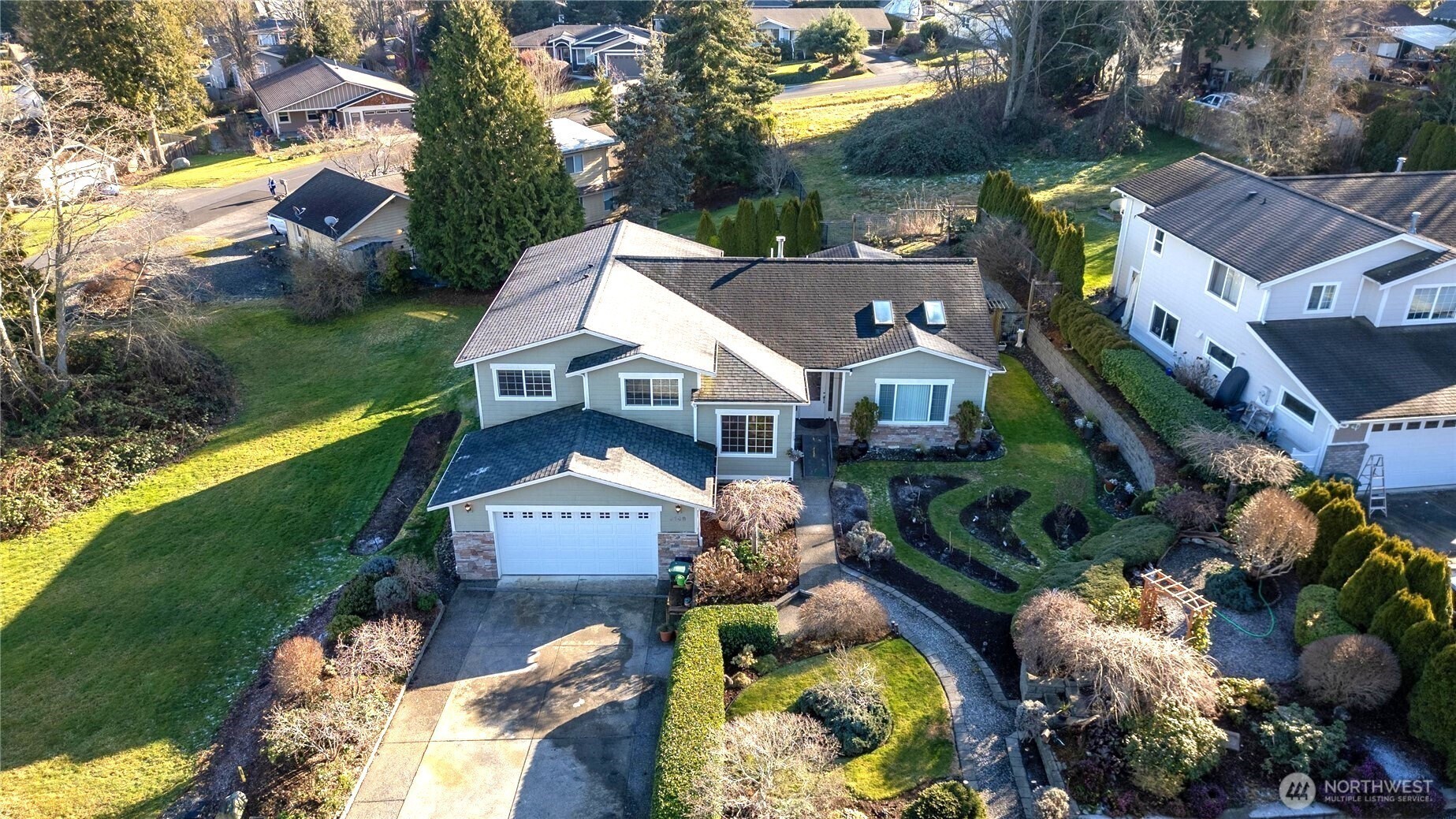 8148 Quinault Road Blaine, WA 98230 - Photo 2 of 40 a view of a house with a yard and a garden
