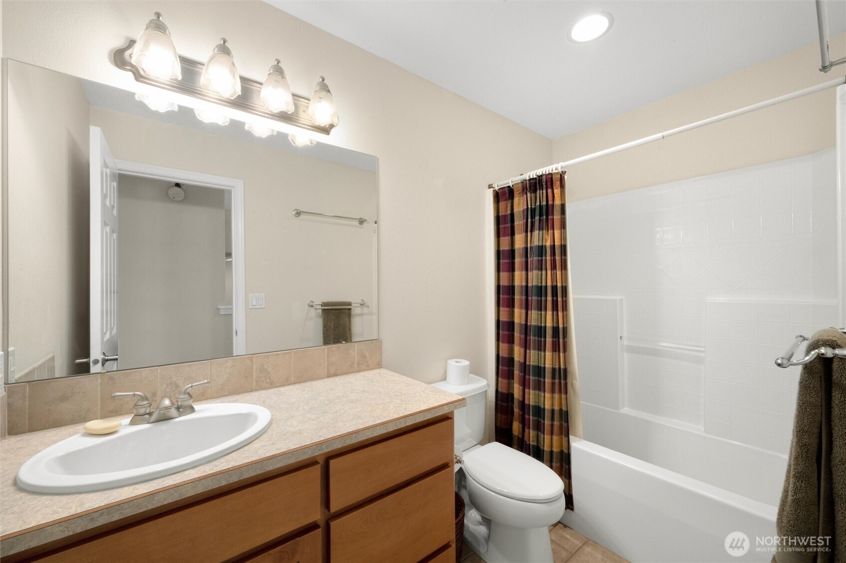 8148 Quinault Road Blaine, WA 98230 - Photo 24 of 40 a bathroom with a sink a toilet a mirror a vanity and shower