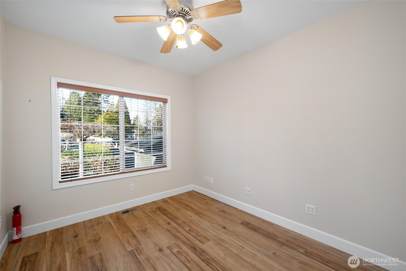 8148 Quinault Road Blaine, WA 98230 - Photo 26 of 40 a view of an empty room with wooden floor and a window