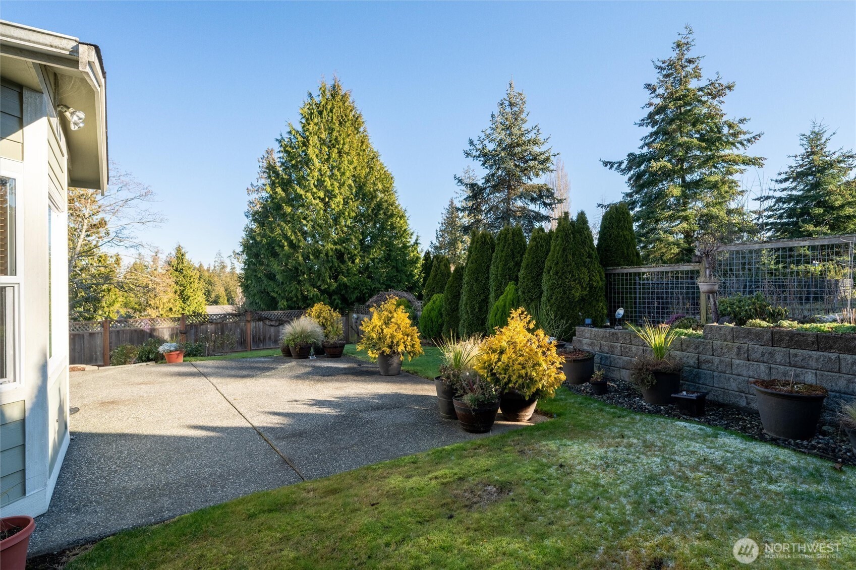 8148 Quinault Road Blaine, WA 98230 - Photo 31 of 40 a backyard of a house with barbeque oven and outdoor seating