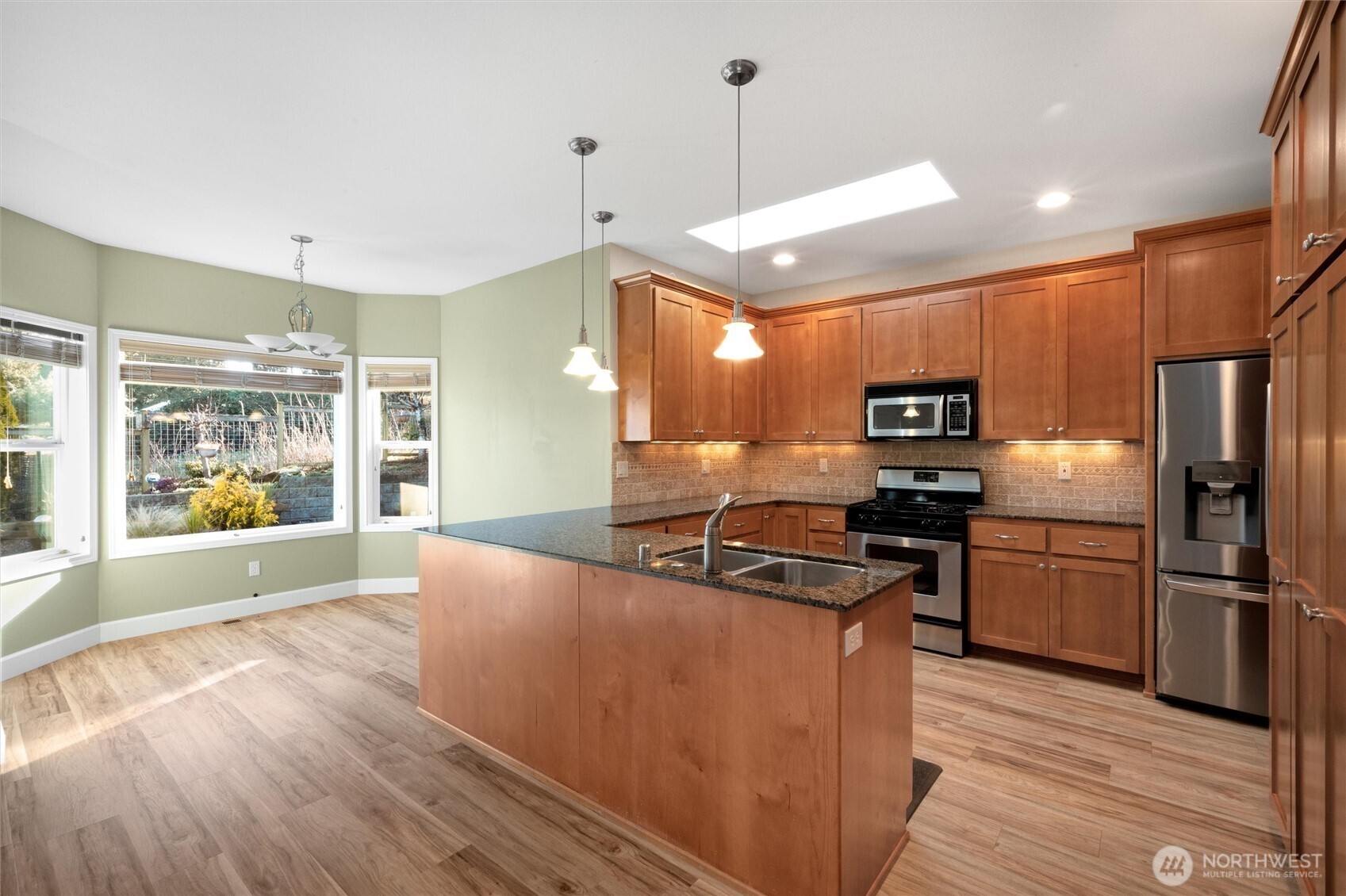 8148 Quinault Road Blaine, WA 98230 - Photo 9 of 40 a kitchen with stainless steel appliances a refrigerator a stove a sink and a hard wood floors