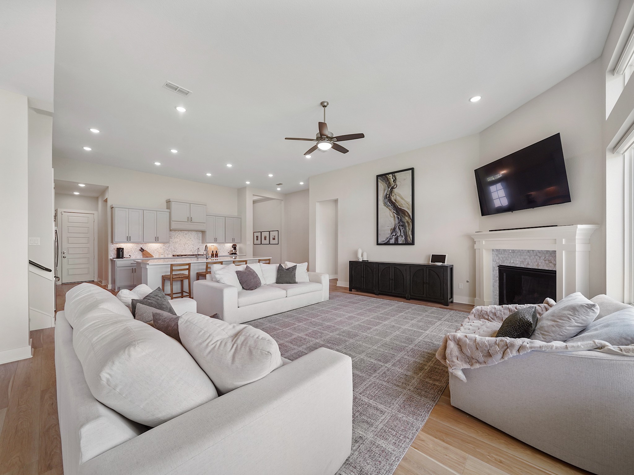 5802 Emerald Ranch Lane Fulshear, TX 77441 - Photo 17 of 45 Thoughtfully designed with oversized windows and an open layout, the living area feels both spacious and comfortable while offering beautiful backyard views and effortless flow throughout the main floor.