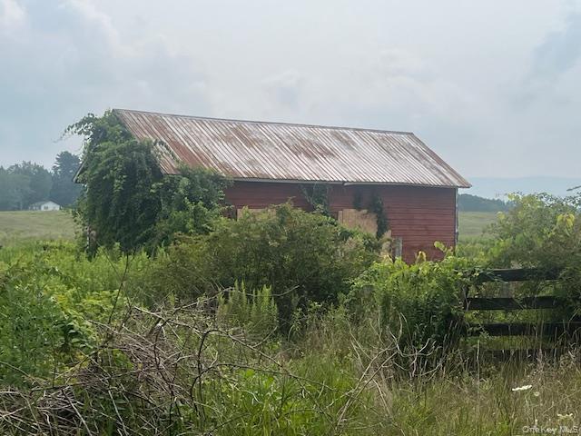 1820 County Route 7 Ancram, NY 12502 - Photo 19 of 31 a aerial view of a house with a yard and potted plants