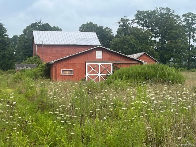 1820 County Route 7 Ancram, NY 12502 - Photo 21 of 31 a front view of a house with garden
