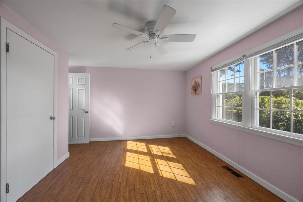 12 Spoonbill Road Dennis, MA 02670 - Photo 15 of 26 a view of empty room with wooden floor and fan