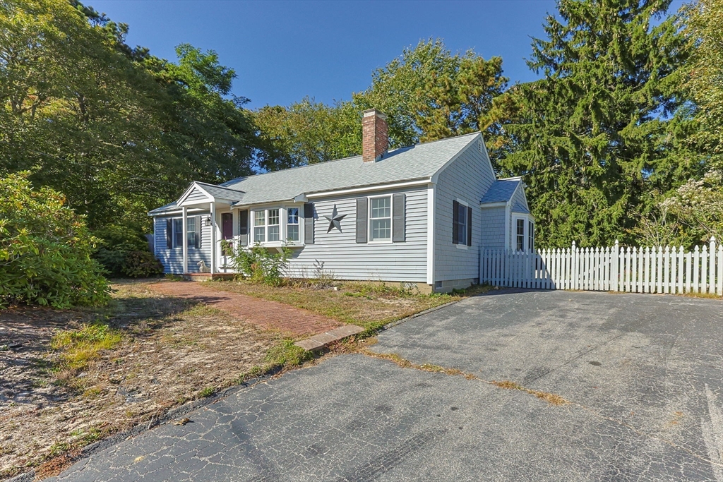 12 Spoonbill Road Dennis, MA 02670 - Photo 2 of 26 a view of a house with a yard and large tree
