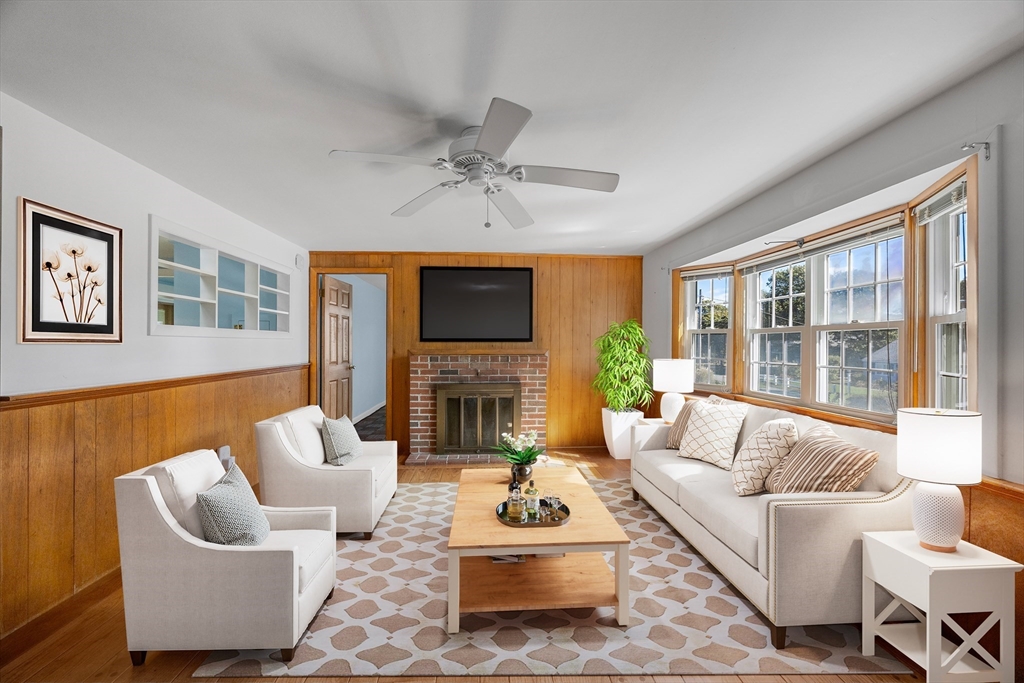 12 Spoonbill Road Dennis, MA 02670 - Photo 3 of 26 a living room with furniture a fireplace and a flat screen tv