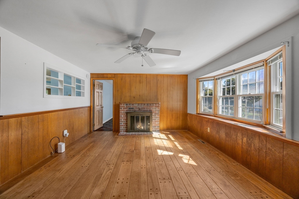 12 Spoonbill Road Dennis, MA 02670 - Photo 4 of 26 a view of a livingroom with wooden floor and a fireplace