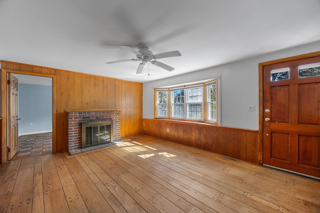12 Spoonbill Road Dennis, MA 02670 - Photo 5 of 26 wooden floor fireplace and windows in an empty room