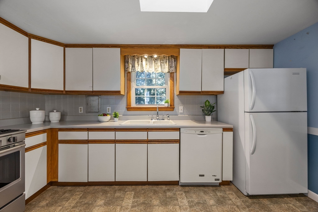 12 Spoonbill Road Dennis, MA 02670 - Photo 7 of 26 a kitchen with white cabinets and white appliances