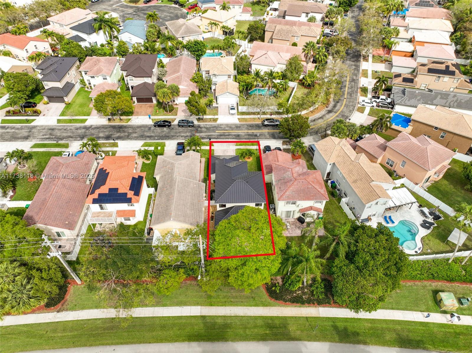 an aerial view of residential houses with outdoor space and parking