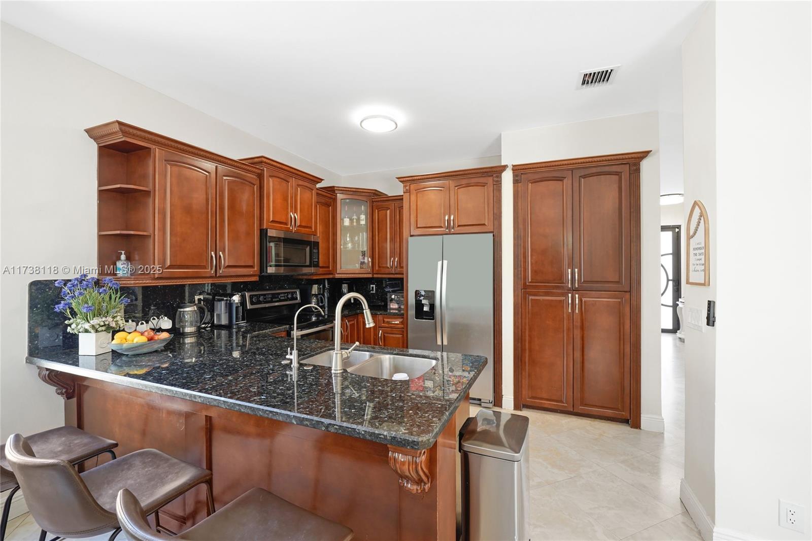 Silver Shores Miramar, FL 33027 - Photo 15 of 42 a kitchen with a refrigerator and a sink