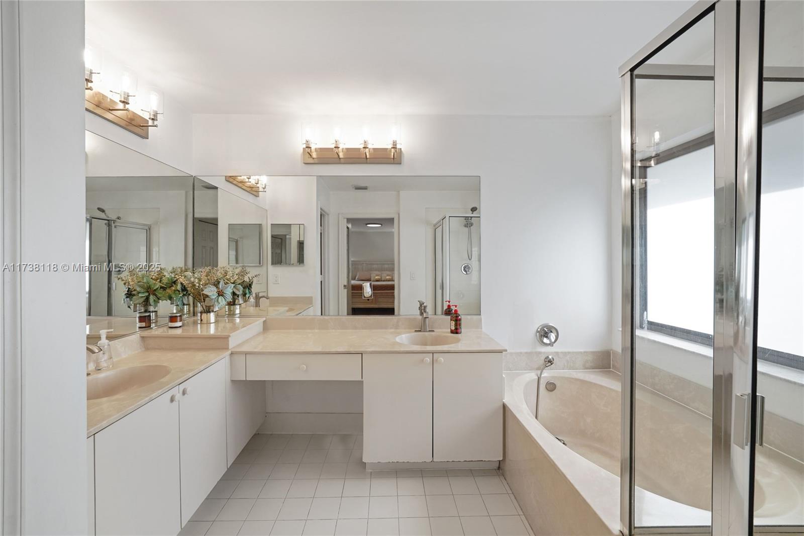 Silver Shores Miramar, FL 33027 - Photo 20 of 42 a large bathroom with a double vanity sink a mirror and a bathtub