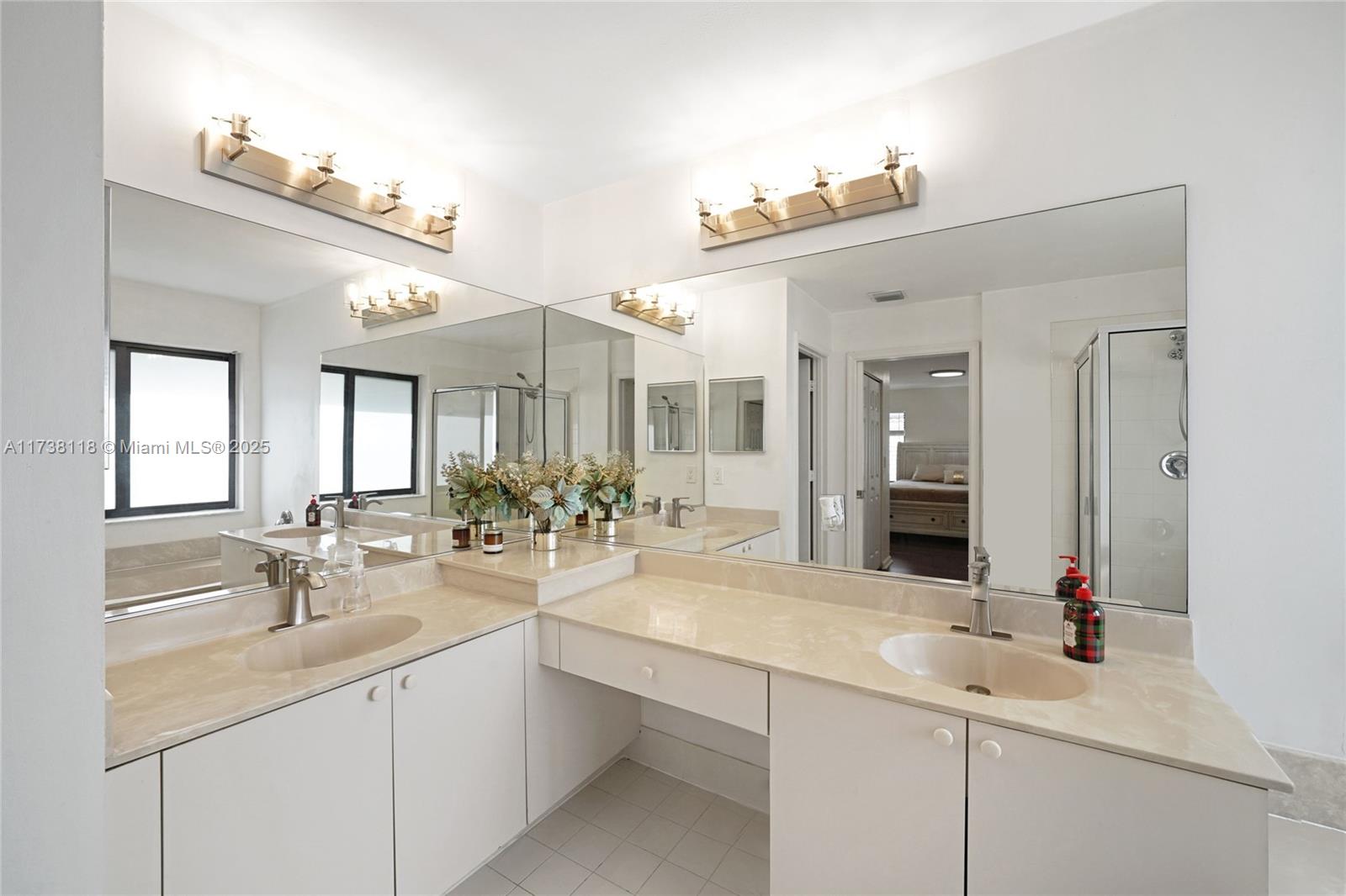 Silver Shores Miramar, FL 33027 - Photo 21 of 42 a bathroom with double vanity sinks a vanity a lamp and a mirror