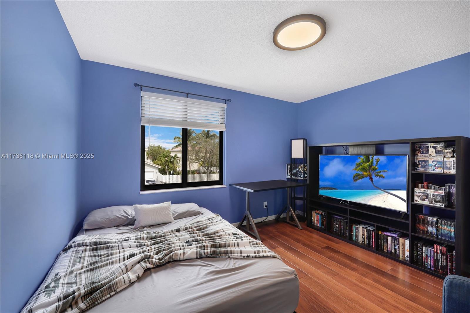 Silver Shores Miramar, FL 33027 - Photo 25 of 42 a bedroom with a bed and a flat screen tv