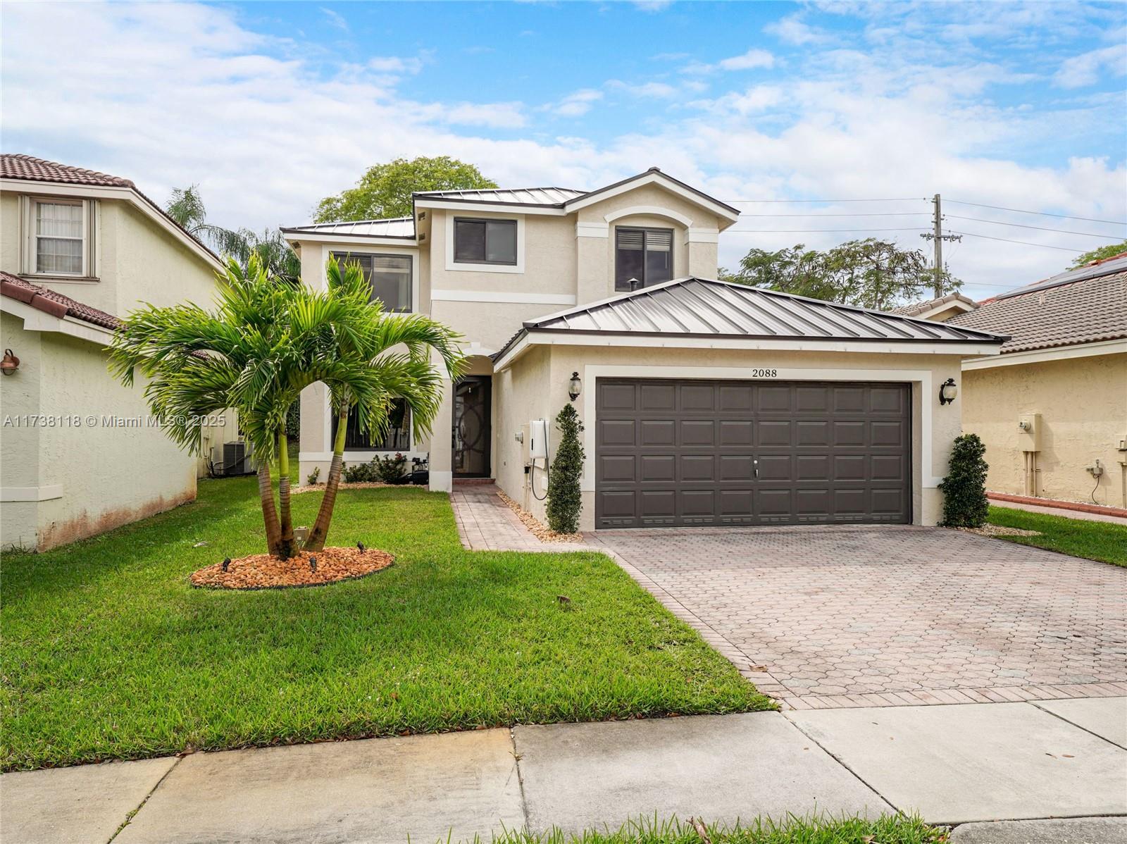 Silver Shores Miramar, FL 33027 - Photo 3 of 42 a front view of a house with a yard and garage