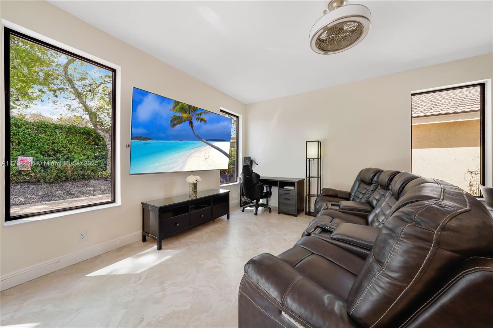 Silver Shores Miramar, FL 33027 - Photo 10 of 42 a living room with furniture a table and a large window