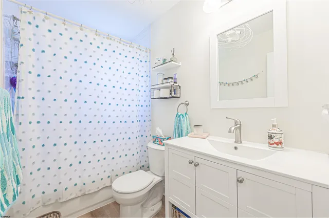 a bathroom with a sink toilet and a mirror