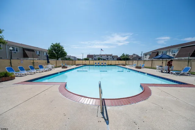 a view of a swimming pool with a lounge chair