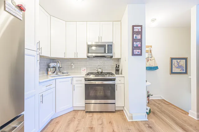 a kitchen with a sink cabinets and stainless steel appliances