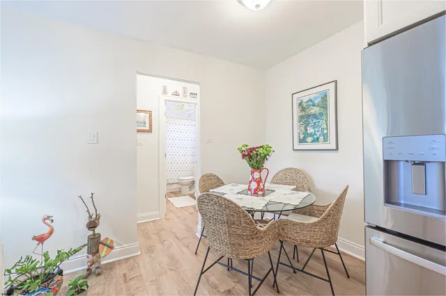 a dining room with furniture and wooden floor