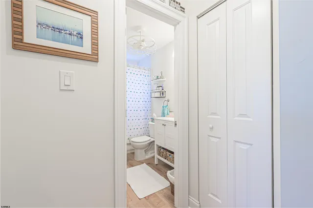 a bathroom with a toilet and a shower