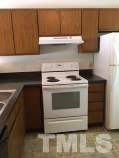 2709 Big Oak Street Raleigh, NC 27610 - Photo 5 of 12 a stove top oven sitting inside of a kitchen