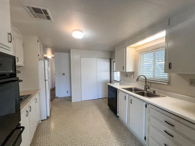 a kitchen with a sink stove and refrigerator